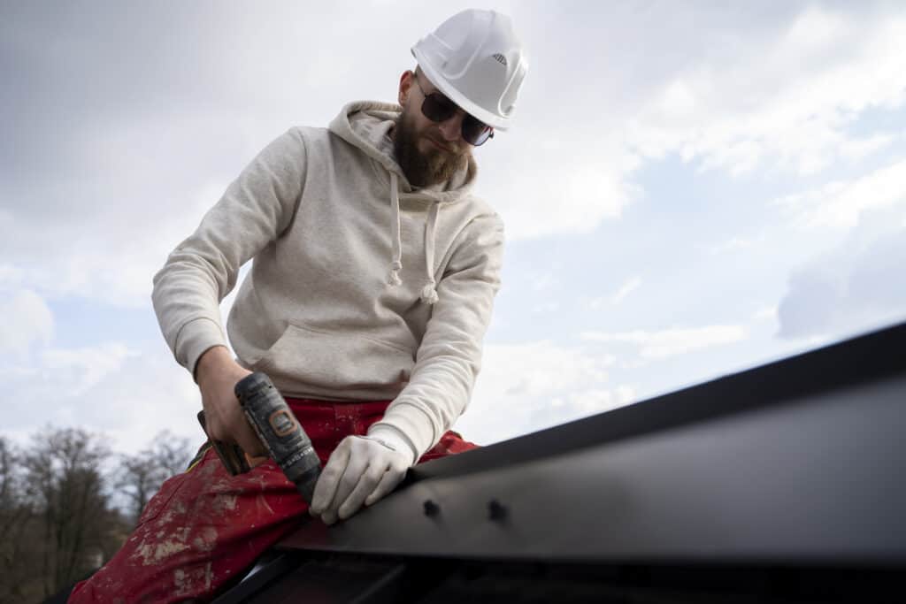 Install Metal Roof Trim ...an-working-with-protection-helmet-scaled